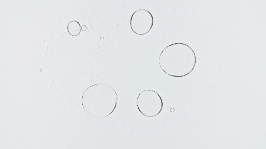 Air bubbles in a petri dish close up indicating purity and clarity.